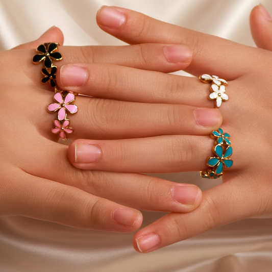 Plusieurs bagues dorées ajustables en acier inoxydable avec trois fleurs en émail, portées sur la main d’une femme, bijou bohème, disponible en bleu, rose, noir et blanc
