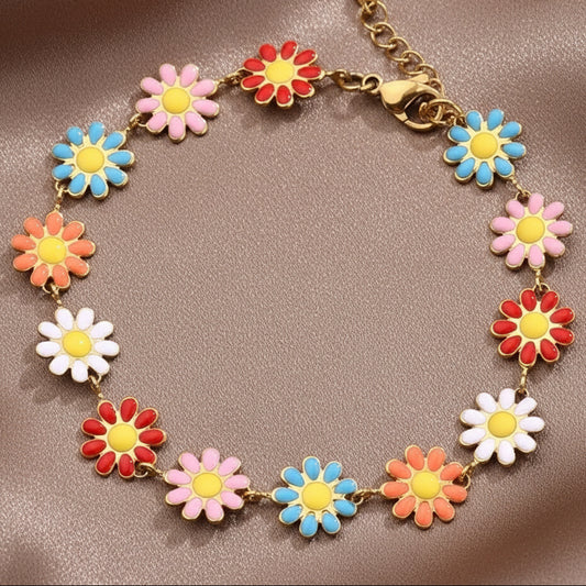 Bracelet en acier inoxydable doré avec petites fleurs marguerite multicolores.