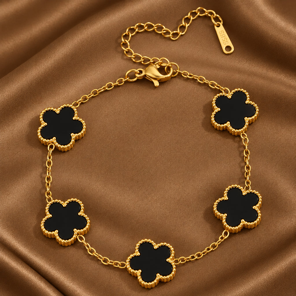 Bracelet en acier inoxydable 316L doré orné de 5 fleurs noires en pierre naturelle.