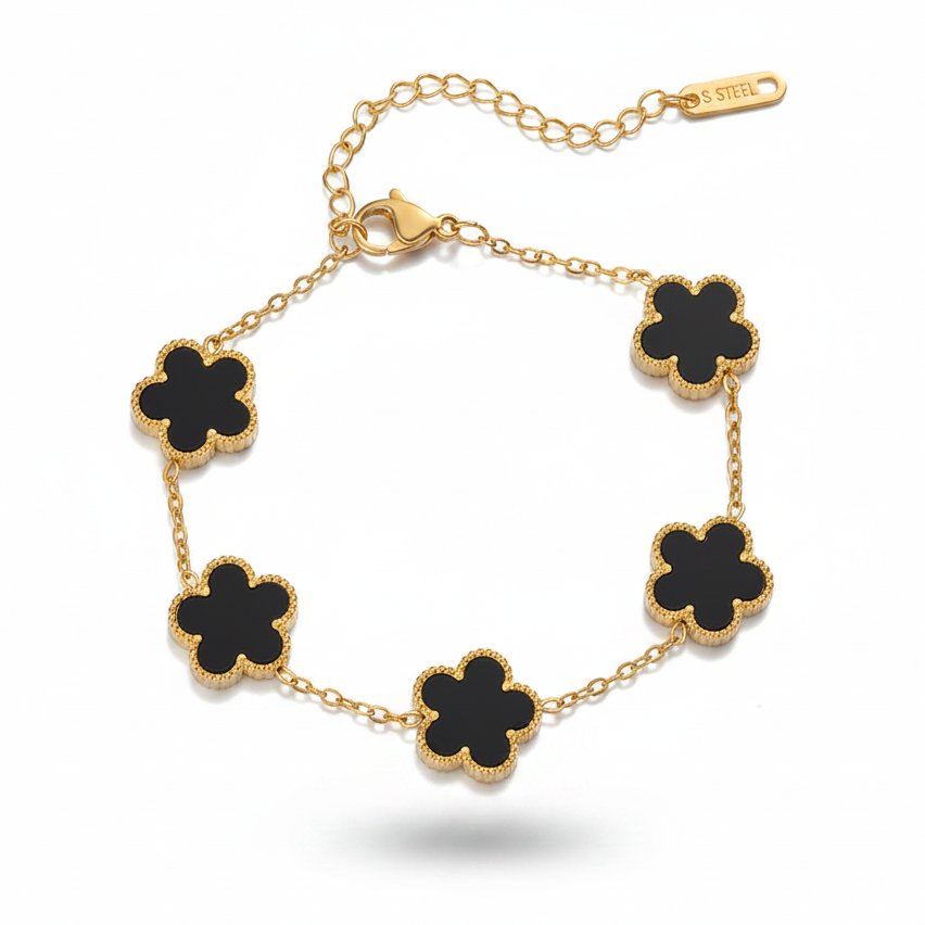 Bracelet en acier inoxydable 316L doré orné de 5 petites fleurs noires en pierre naturelle.
