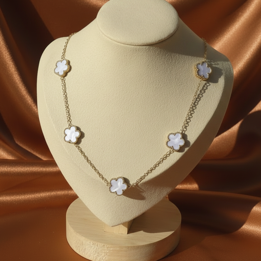 Collier doré en acier inoxydable avec 5 petites fleurs blanches en nacre.