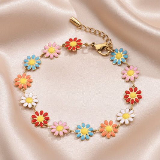 Bracelet en acier inoxydable doré avec petites fleurs marguerite multicolores.