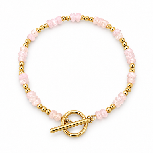 Bracelet en acier inoxydable doré et  perles de quartz rose naturel. Fermeture en T.