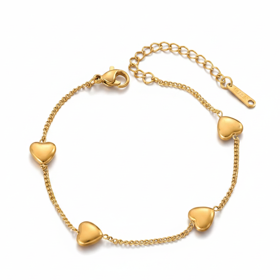 Bracelet en acier inoxydable 316L doré à maille gourmette fine ornée de 4 cœurs.