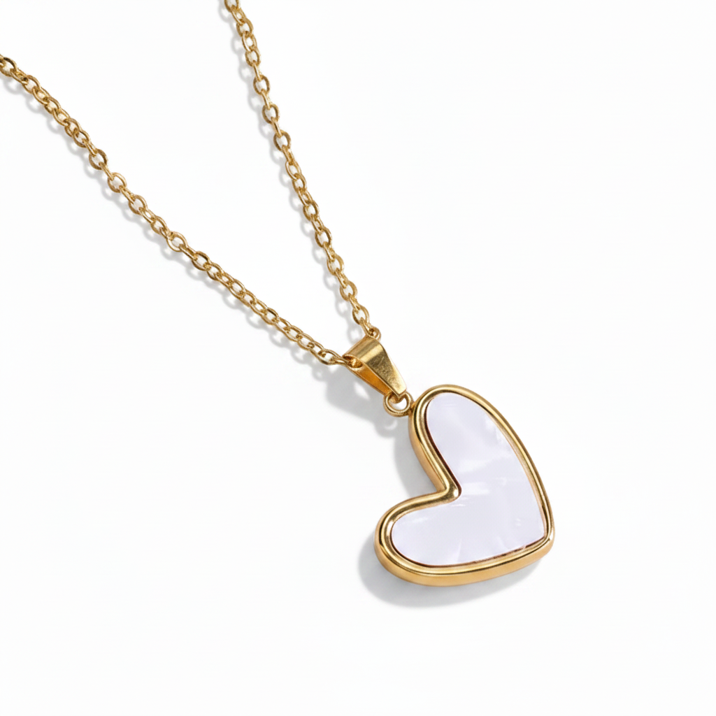 Collier doré en acier inoxydable 316L à fine chaîne maille forçat avec pendentif cœur stylisé en nacre.