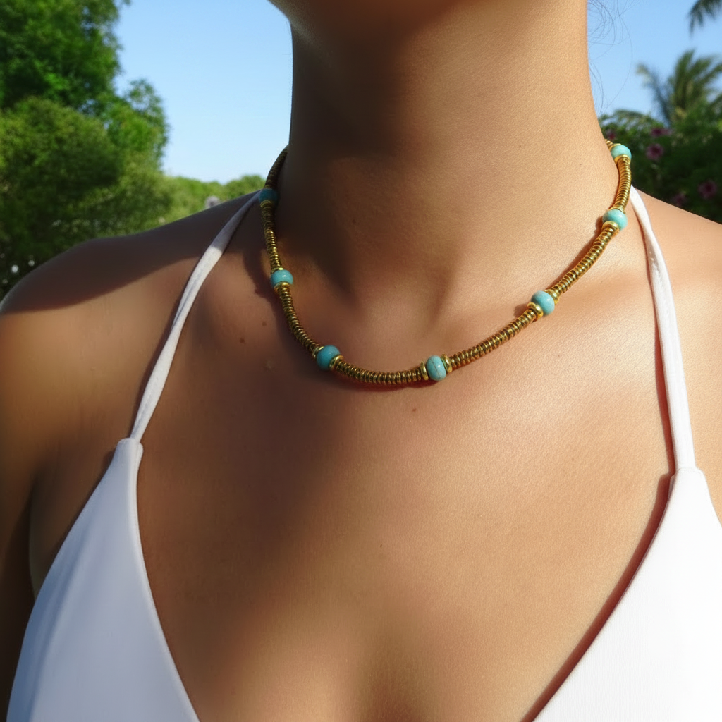 Collier doré en acier inoxydable 316L avec pierres naturelles turquoise porté par une femme.