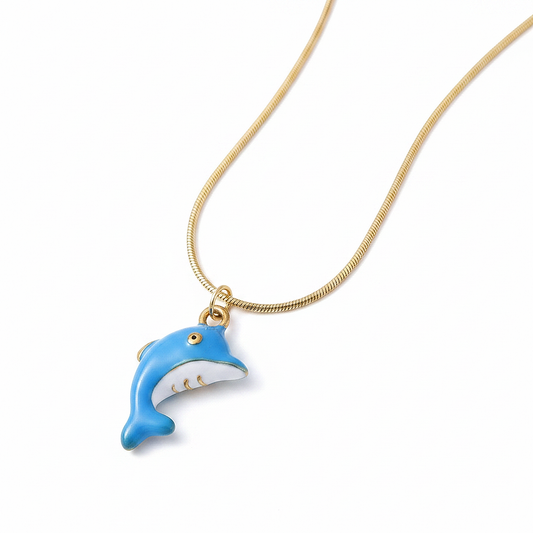 Gros plan sur un collier enfant en acier 316L doré orné d'un pendentif dauphin émaillé bleu.