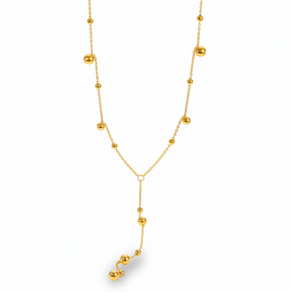 Collier cravate doré en acier inoxydable à fine chaîne maille forçat et perles dorées.