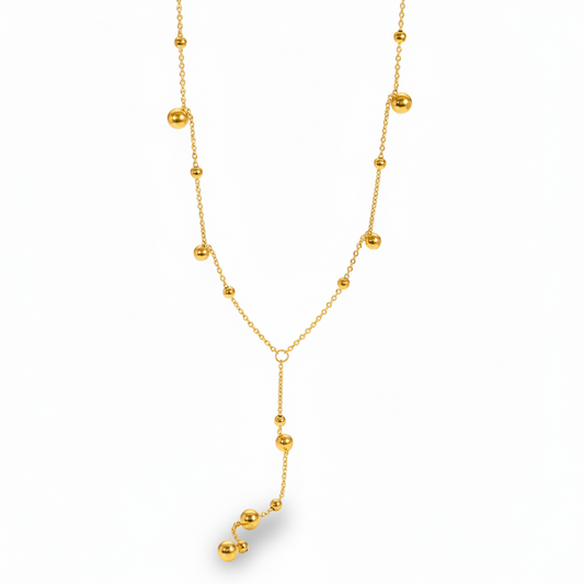 Collier cravate doré en acier inoxydable à fine chaîne maille forçat et perles dorées.