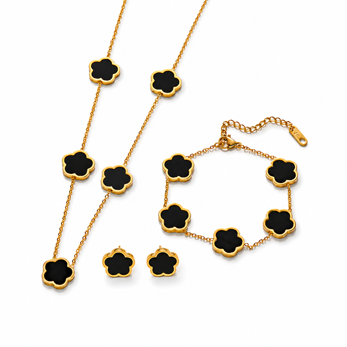 Parure comprenant bracelet, collier et boucles en acier inoxydable 316L doré ornés de petites fleurs en nacre noire.
