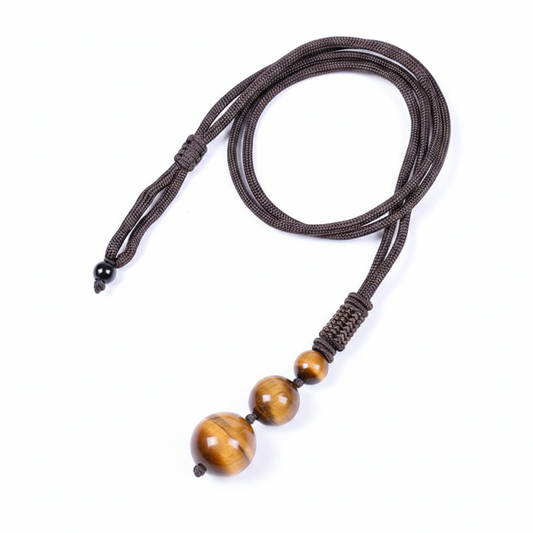 Pendentif trio en œil de tigre boules de 16, 12 et 8 mm avec cordon en nylon marron.